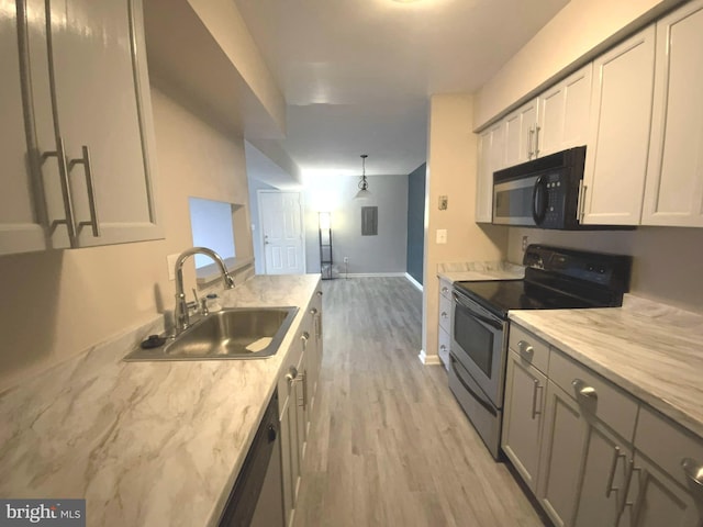 kitchen with sink, gray cabinetry, light wood-type flooring, pendant lighting, and stainless steel appliances