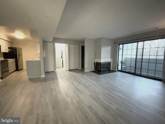 unfurnished living room featuring light hardwood / wood-style flooring