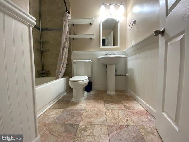 bathroom featuring shower / bath combination with curtain and toilet