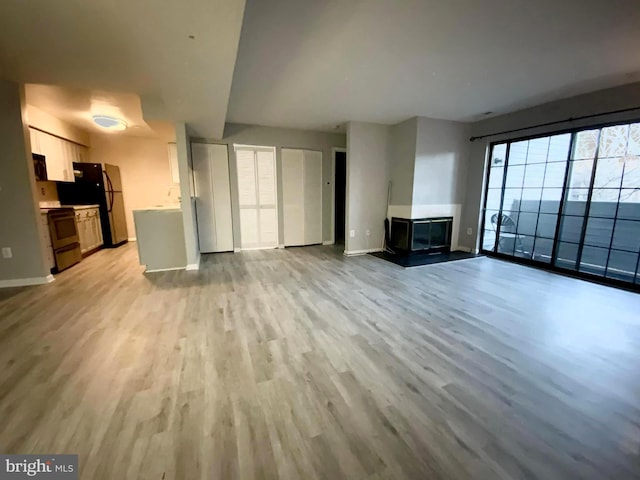 unfurnished living room featuring light hardwood / wood-style flooring