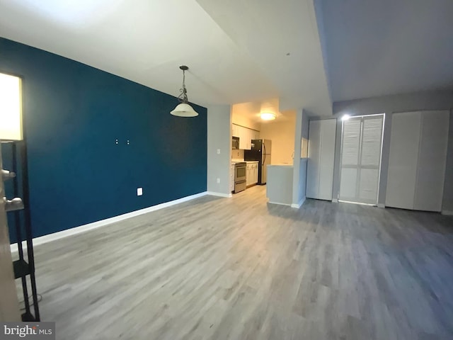 unfurnished living room with light wood-type flooring