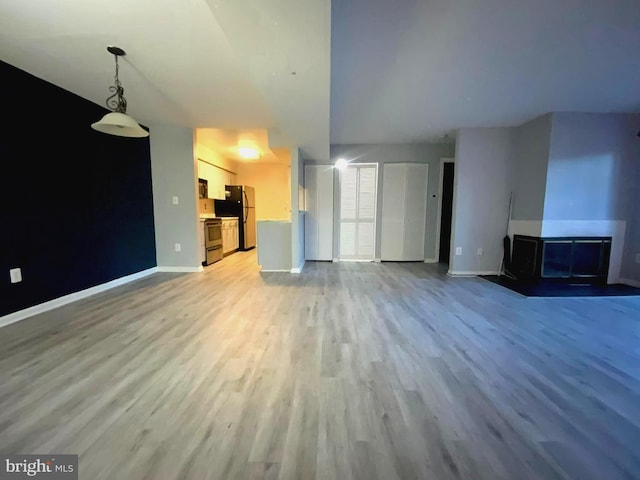 unfurnished living room with light hardwood / wood-style flooring