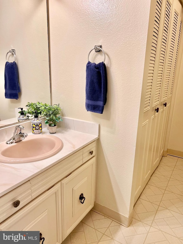 bathroom featuring baseboards and vanity