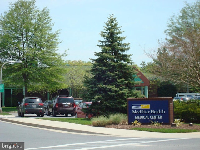 exterior space with curbs, sidewalks, and street lights