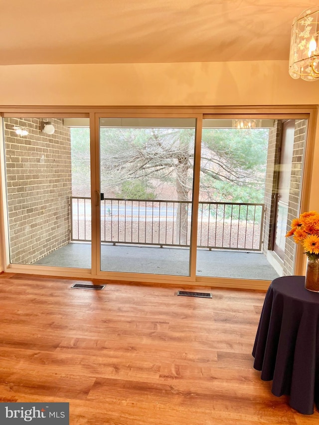 doorway featuring wood finished floors and visible vents