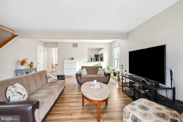 living room featuring light wood finished floors and visible vents