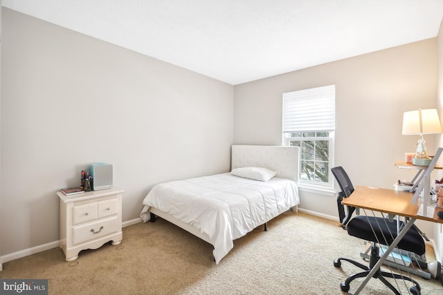 carpeted bedroom with baseboards