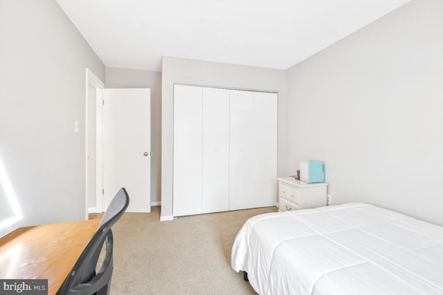 bedroom featuring a closet and light carpet