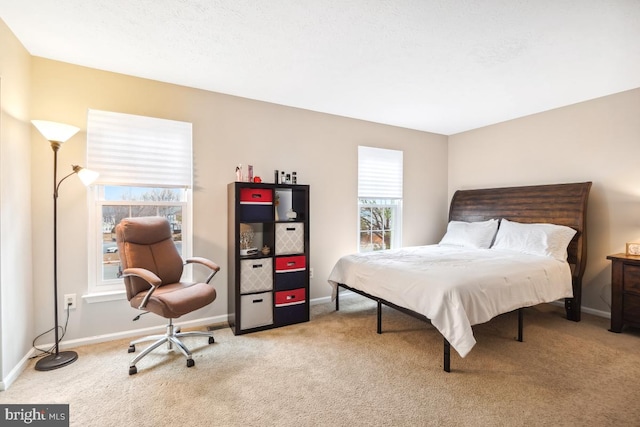 bedroom featuring baseboards and light colored carpet