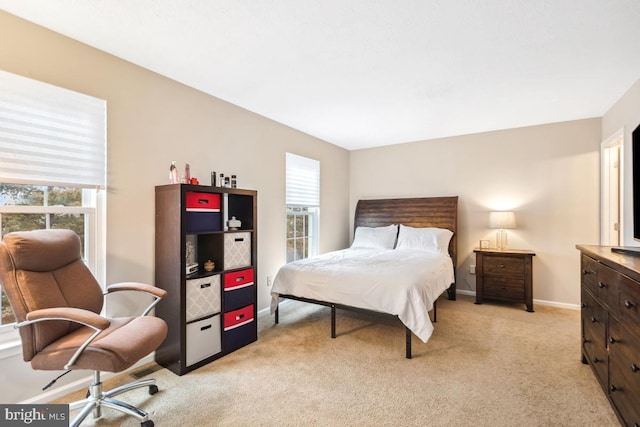 bedroom featuring baseboards and light colored carpet