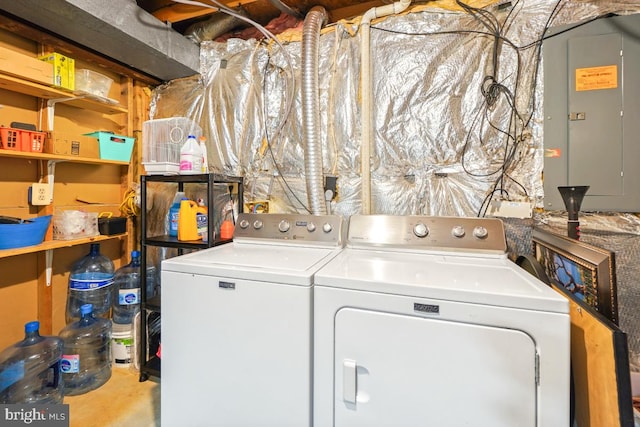 laundry area featuring laundry area, electric panel, and washer and clothes dryer