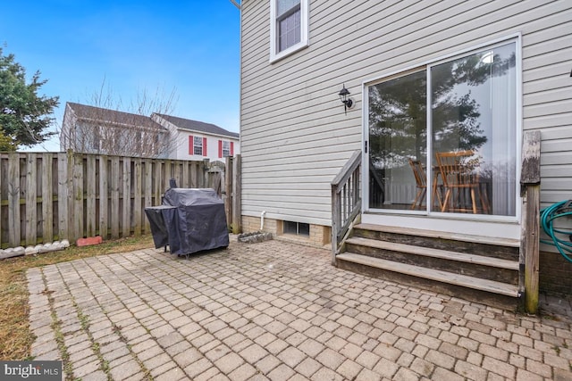 view of patio / terrace with entry steps, fence, and grilling area