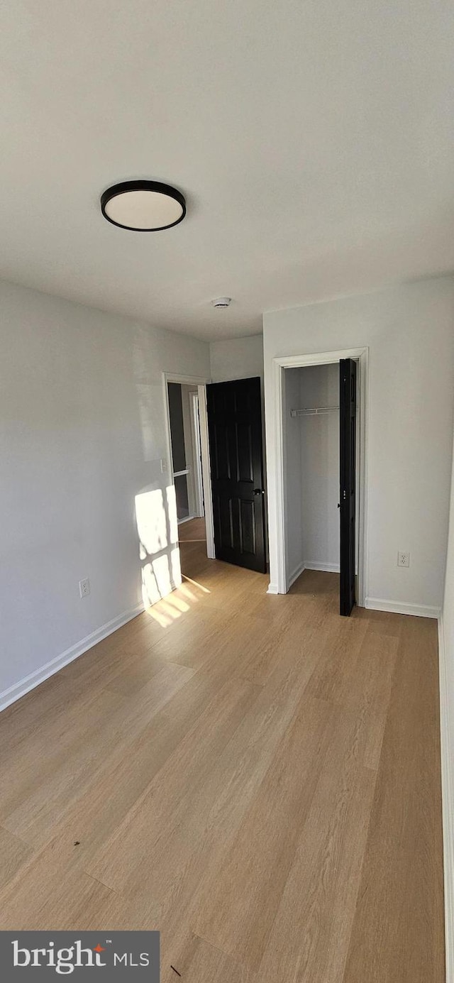 unfurnished room with light wood-type flooring