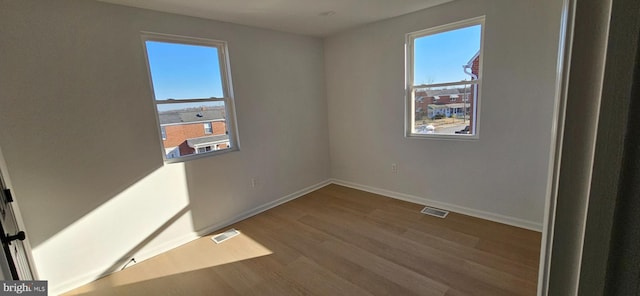 unfurnished room featuring hardwood / wood-style flooring