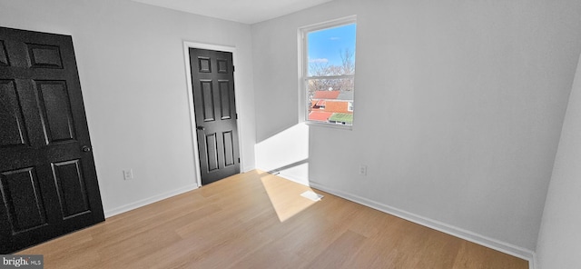 spare room featuring light hardwood / wood-style floors