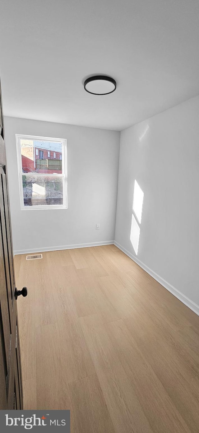 spare room featuring light hardwood / wood-style floors