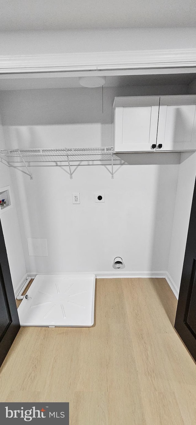 washroom featuring electric dryer hookup, washer hookup, and light hardwood / wood-style floors