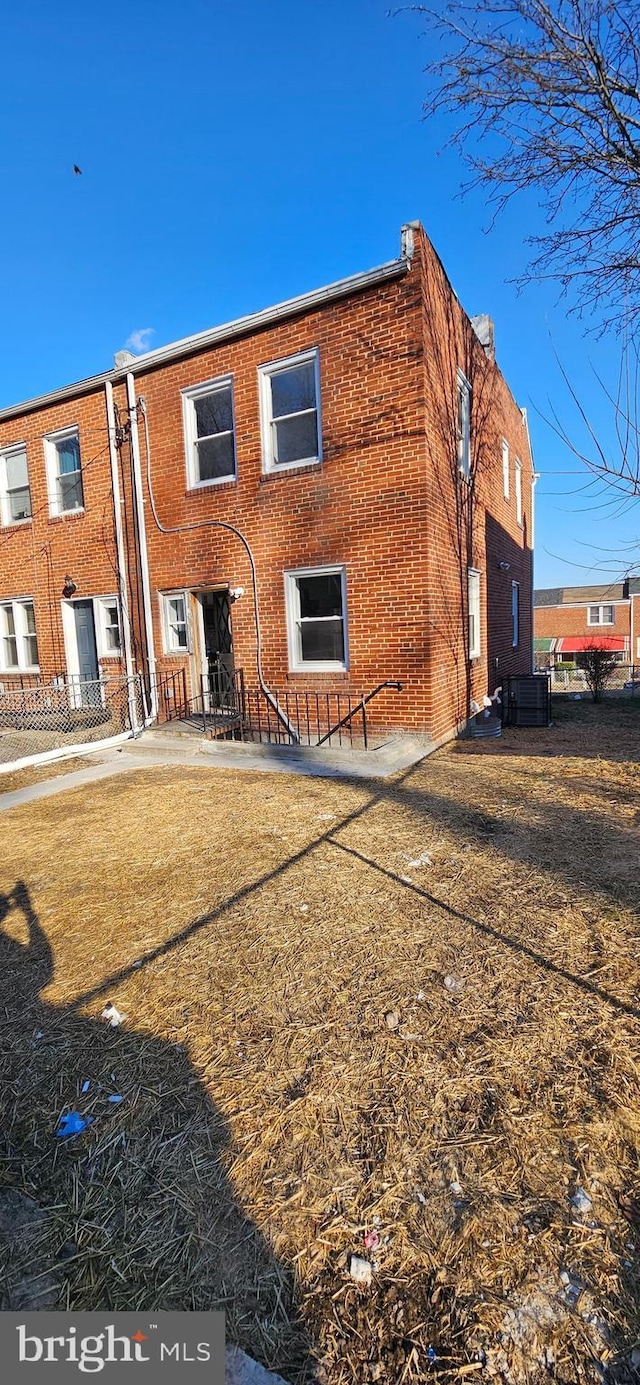 rear view of house with central AC