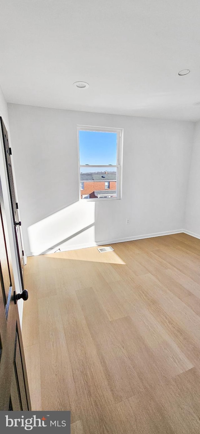 spare room featuring light hardwood / wood-style floors