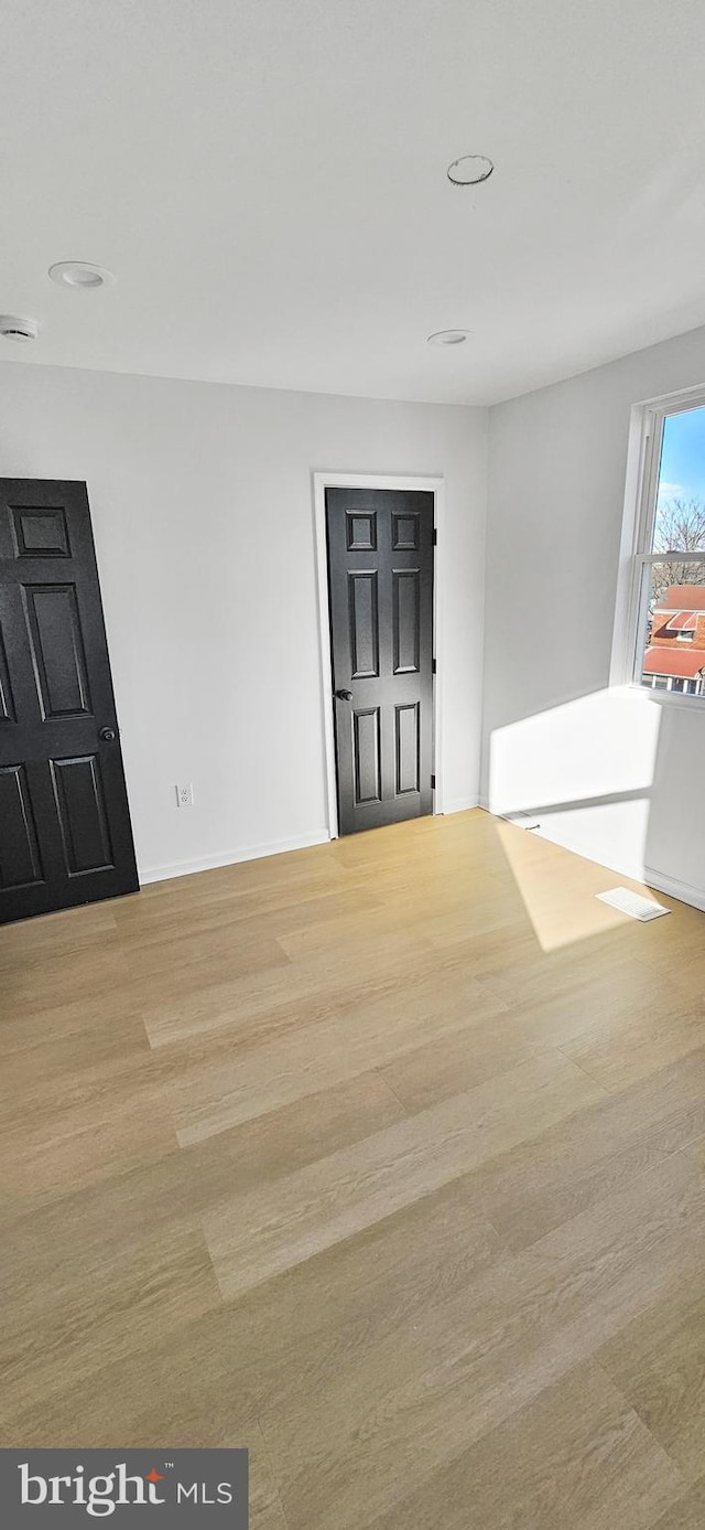 unfurnished room with light hardwood / wood-style flooring