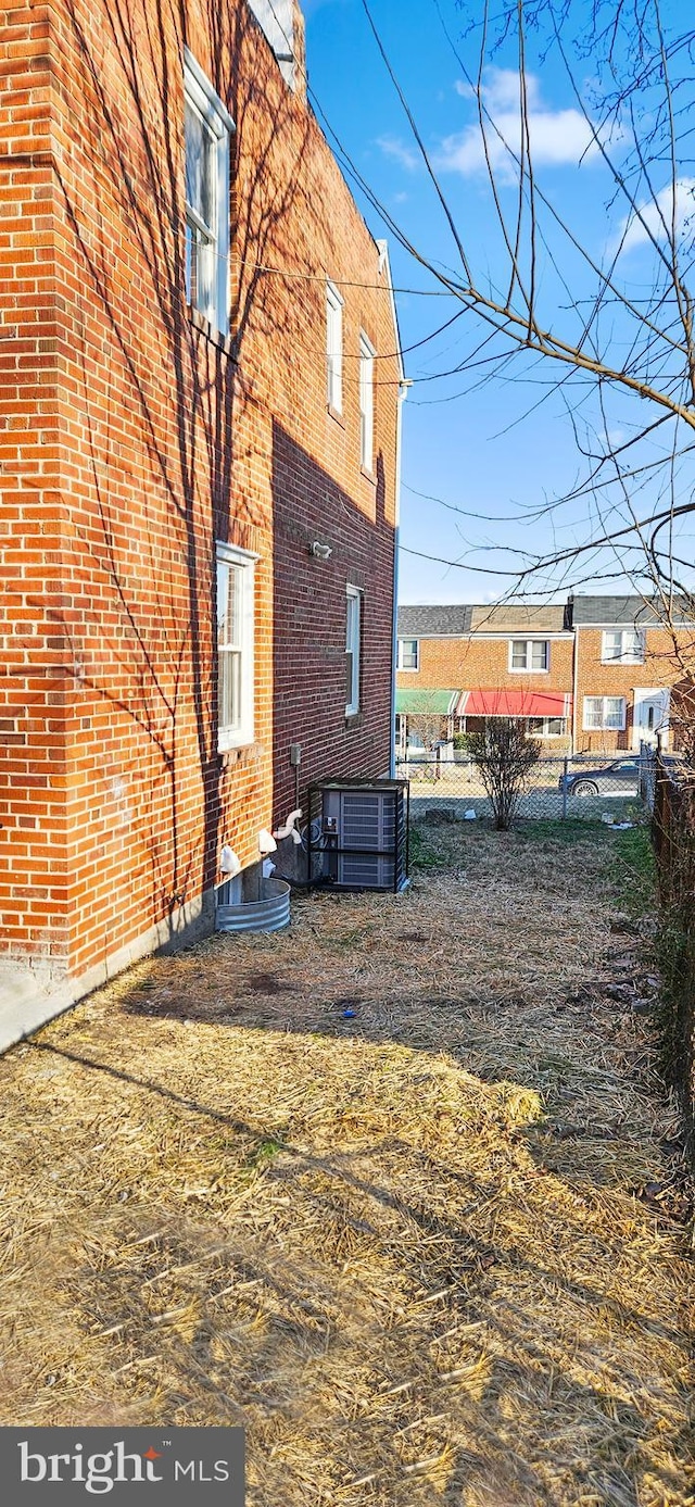 view of side of property with central air condition unit