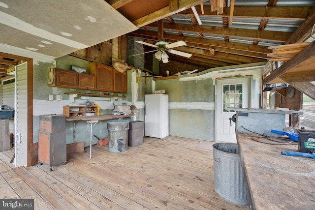 kitchen featuring white refrigerator, ceiling fan, lofted ceiling, and light hardwood / wood-style flooring