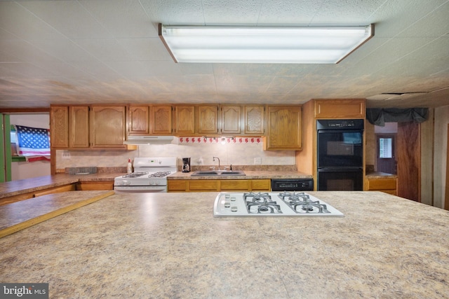 kitchen featuring sink and white appliances