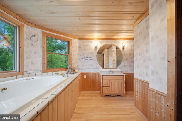 bathroom with hardwood / wood-style flooring, vanity, a healthy amount of sunlight, and wooden ceiling