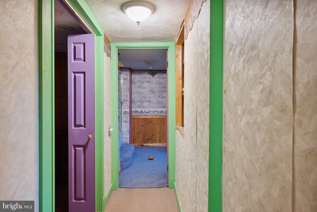 hallway featuring a textured ceiling