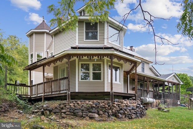 exterior space featuring a porch and a front lawn