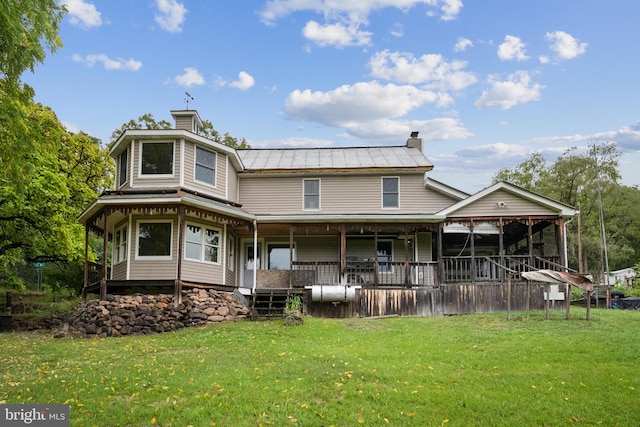 back of house with a porch and a yard