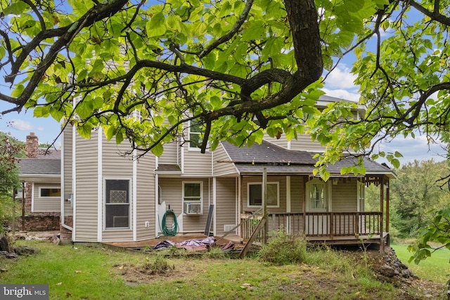 back of house featuring cooling unit and a lawn