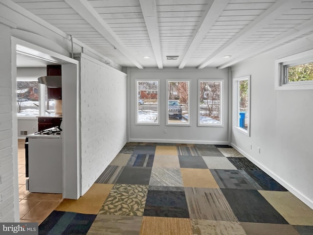 unfurnished sunroom with beamed ceiling