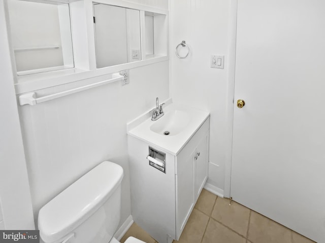 bathroom with vanity, tile patterned flooring, and toilet