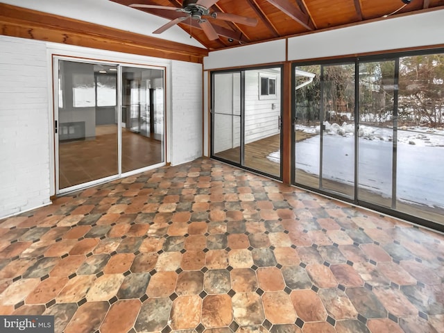 unfurnished sunroom featuring vaulted ceiling with beams, wood ceiling, and ceiling fan