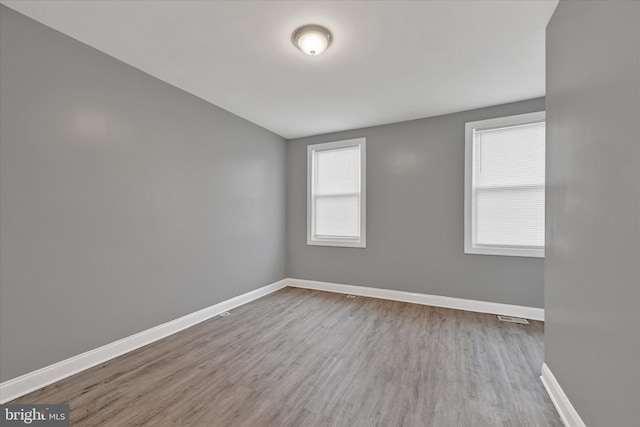 spare room featuring light hardwood / wood-style floors