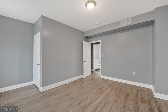 unfurnished room with hardwood / wood-style flooring