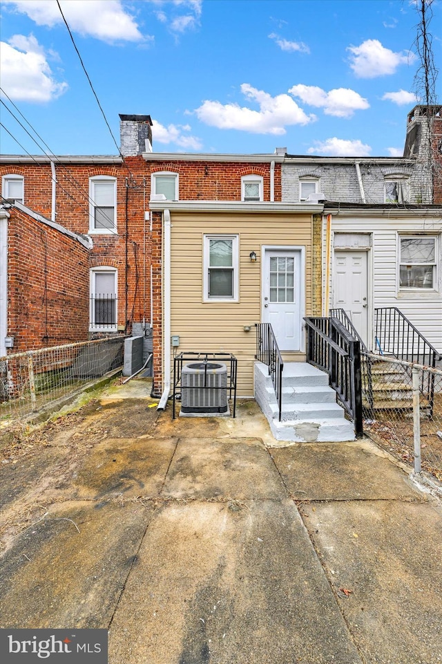 back of house featuring central AC unit and a patio area