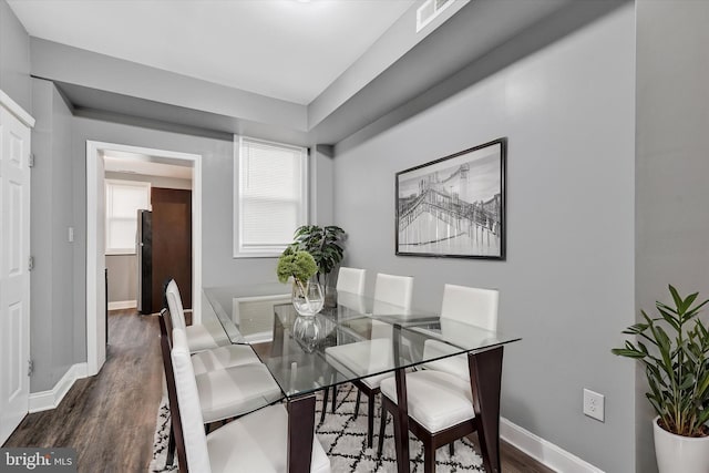 dining area featuring dark wood-type flooring