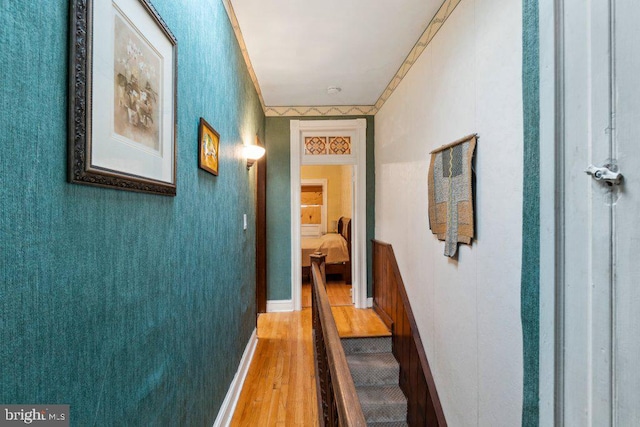 corridor with hardwood / wood-style flooring