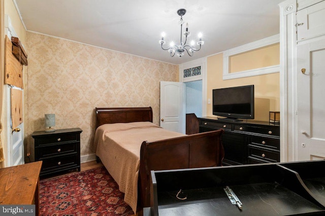 bedroom featuring a notable chandelier and dark wood-type flooring