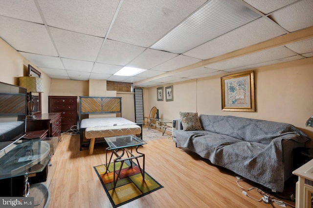 bedroom featuring hardwood / wood-style flooring and a paneled ceiling