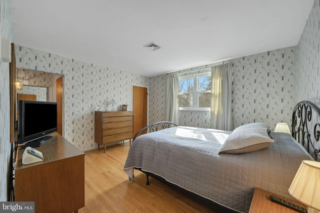 bedroom with light wood-type flooring