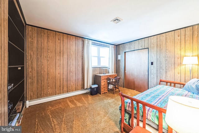 bedroom with a baseboard heating unit, dark carpet, wooden walls, and a closet