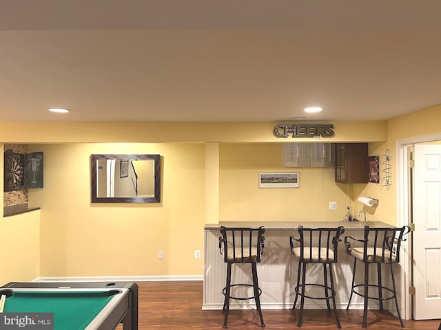 playroom with dark hardwood / wood-style floors and bar