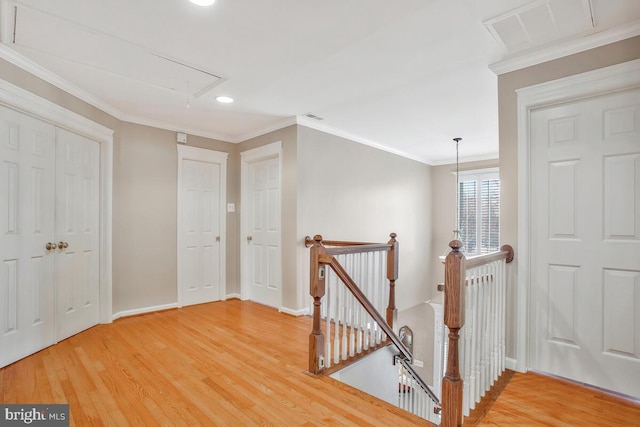 hall with hardwood / wood-style floors and ornamental molding