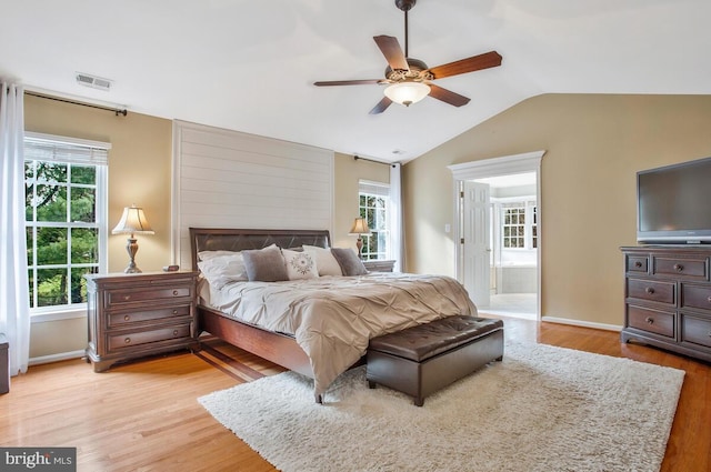 bedroom featuring lofted ceiling, ceiling fan, and light wood-type flooring