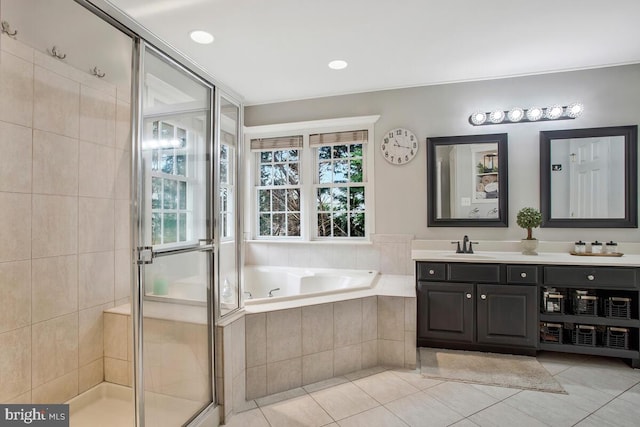 bathroom featuring tile patterned flooring, vanity, and separate shower and tub