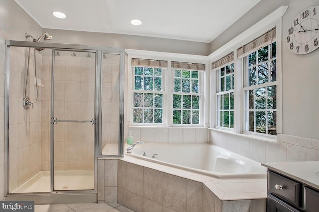 bathroom featuring tile patterned floors, vanity, and shower with separate bathtub