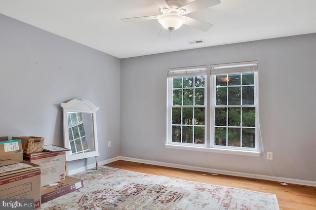 unfurnished office featuring light hardwood / wood-style floors and ceiling fan